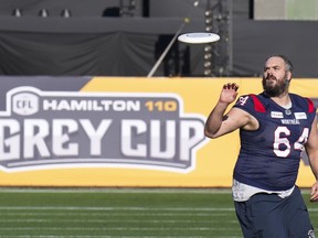 Montreal Alouettes' offensive lineman Sean Jamieson (64) plays Frisbee during a walk-through in Hamilton, Ont., on Saturday, Nov. 18, 2023. The Alouettes will take on the Winnipeg Blue Bombers in the 110th CFL Grey Cup on Sunday.