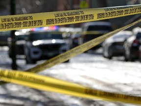Police crime scene tape on Langside Street in the West Broadway area of Winnipeg on Sunday, Nov. 26, 2023. At least three people were killed in a shooting during the early morning hours.