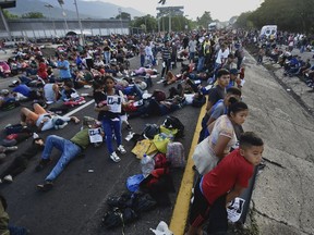 Migrants block the highway during their caravan through Huixtla, Mexico, Wednesday, Nov. 8, 2023. About 3,000 migrants, mostly from Central America, are protesting for the government to issue them temporary documents allowing them to continue north to the U.S. border.