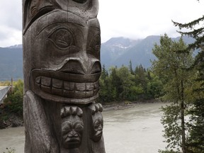 One of four totem poles on the corners of a bridge over the Nass River to Gitwinksihlkw (Canyon City) in northwestern British Columbia is seen on Saturday, Sept. 1, 2018. The eight-metre tall poles each represent a different animal crest of the Nisga'a people.