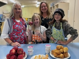 education assistant naomi newbery (left) and principal misty terpstra with student volunteers, serving breakfast at salmo elementary school.