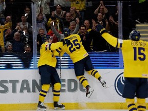 Sweden's Otto Stenberg (C) celebrates with Canucks prospect Elias Pettersson after scoring the 1-0 goal during a Group A game between Germany and Sweden in the IIHF World Junior Championship in Gothenburg, Sweden on December 28, 2023.