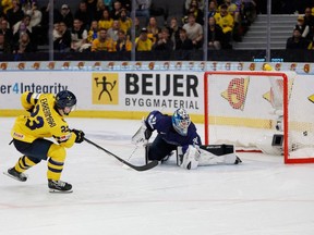 Sweden's Jonathan Lekkerimaki (L) scores a goal past Finland's goalkeeper Noa Vali during penalty shot shootouts at the Group A ice hockey match between Sweden and Finland of the IIHF World unior Championship in Gothenburg, Sweden, on December 31, 2023.