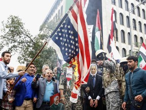 Iranians burn a U.S. flag during an anti-Israeli rally to show their solidarity with Palestinians, in Tehran, on Oct. 13.