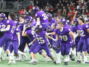 The Vancouver College Fighting Irish celebrate winning the Triple A football provincial title Saturday at B.C. Place. Vancouver College beat North Vancouver's Carson Graham Eagles 21-0, repeating as champions.