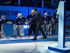 Roberto Luongo walks onto the ice before an NHL game to celebrate the his entry to the Ring of Honour at Rogers Arena in Vancouver on Thursday, Dec. 14, 2023.