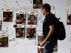 Photographs of Israeli hostages held by Hamas militants on a wall near the Tel Aviv Museum of Art on Nov. 22, 2023.