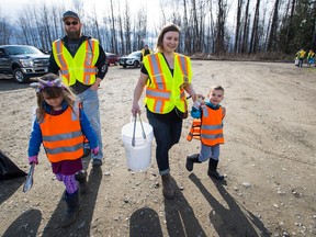 A family collects garbage in a Fraser River cleanup event.
