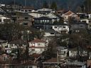 The Real Estate Board of Greater Vancouver says home sales ticked up last month as the continued increase of newly listed properties has given prospective home buyers in the region among the largest selection to choose from since 2021. Houses are seen on a hill in Vancouver, B.C., Thursday, Nov. 23, 2023.