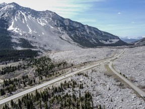 Traffic travels along Highway 3 through the remains of the Frank Slide in the Crowsnest Pass near Blairmore, Alta., on Wednesday, May 3, 2023. On April 29, 1903, a massive landslide buried the town of Frank killing at least 90 people.