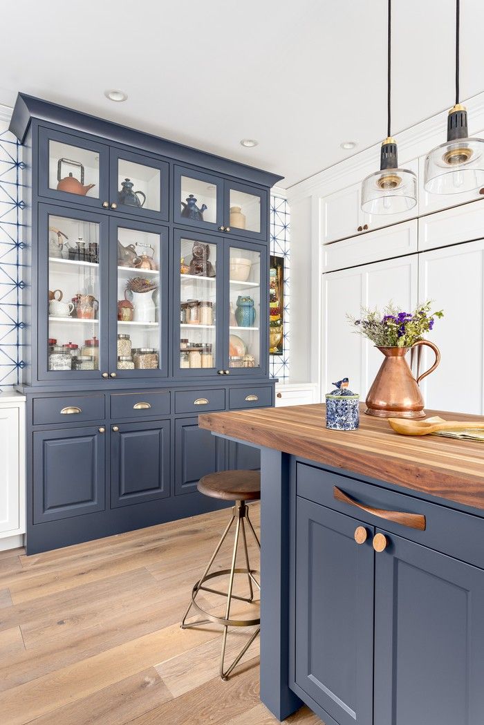 There's a move toward more homey less perfect kitchens. Think the English kitchen brand deVOL known for incorporating artwork, accessories, wallpaper and freestanding furniture or built-ins that evoke furniture like this island or china cabinet. Simply Home Decorating.
