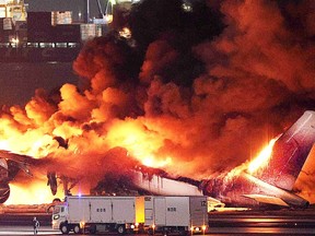 This photo provided by Jiji Press shows a Japan Airlines plane on fire on a runway of Tokyo's Haneda Airport on January 2, 2024.