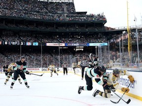 Nicolas Roy #10 of the Vegas Golden Knights is checked by Adam Larsson #6 of the Seattle Kraken during the third period at T-Mobile Park on January 01, 2024 in Seattle, Washington.