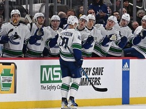 Elias Pettersson of the Vancouver Canucks celebrates with teammates on the bench after scoring a goal in the first period against the Pittsburgh Penguins at PPG PAINTS Arena on January 11, 2024 in Pittsburgh, Pennsylvania.