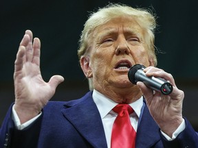 Former U.S. President Donald Trump speaks to voters during a visit to a caucus site in Clive, Iowa, on January 15, 2024.