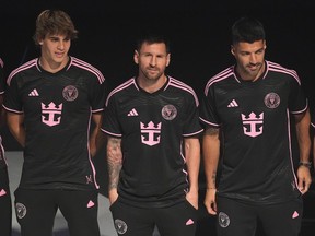 Inter Miami's Lionel Messi, centre, stands with teammates Benjamin Cremaschi, left, and Luis Suarez as they wear new uniforms with the Royal Caribbean International logo during an event on the world's largest cruise ship Icon of the Seas on Jan. 23 in Miami. Messi and Co. visit Vancouver on May 25.
