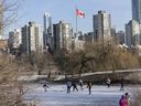 Skaters take advantage of a sheet of ice on the pond in Vanier Park in Vancouver on Saturday. More typical temperatures are expected on the B.C. coast by midweek.