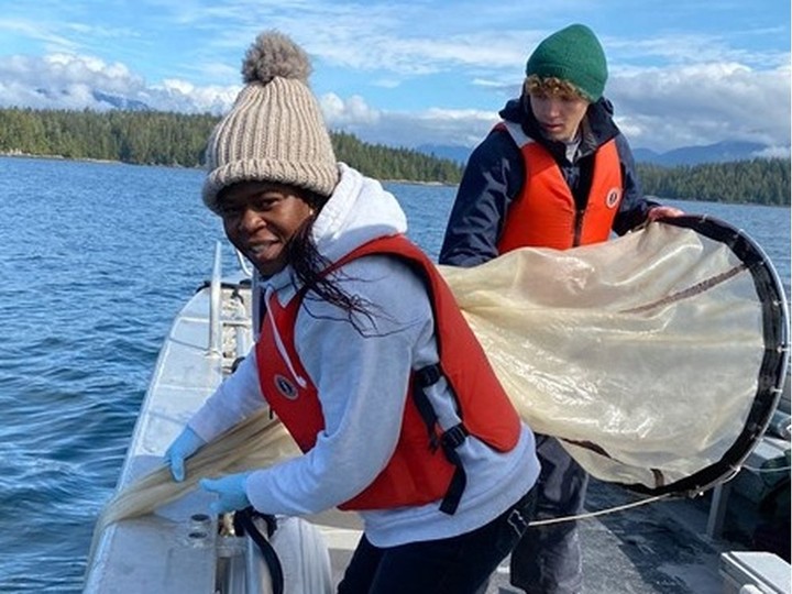  Oladimeji Ayo Iwalaye, a post-doctoral researcher at Ocean Wise and UBC, (left) takes samples from the Strait of Georgia.