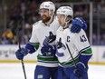 Quinn Hughes is congratulated by Filip Hronek for a goal against the New York Islanders in January.