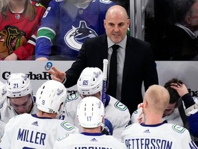 Canucks head coach Rick Tocchet talks to players during a game against the Chicago Blackhawks last month.