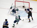 St. Louis Blues' Pavel Buchnevich is unable to score past Vancouver Canucks goaltender Thatcher Demko and Ian Cole during the first period of an NHL game Thursday, Jan. 4, 2024, in St. Louis.