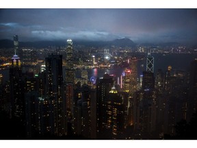 Illuminated buildings are seen from Victoria Peak at dusk in Hong Kong, China, on Friday, Jan. 22, 2016.