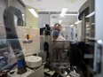 Dr. Marc Romney, Head of Medical Microbiology and Virology watches a new AI-assisted machine to help the microbiology lab at St. Paul's Hospital in Vancouver on Tuesday, January 23, 2024. St. Paul's has installed a new $1 million automated AI-based lab system which uses artificial intelligence and robots for repetitive tasks so humans can do the complex work.