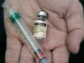 B.C. is extending eligibility for free vaccines against the human papillomavirus to men born in 2005. In this Aug. 28, 2006, file photo, a doctor holds a vial of the HPV vaccine Gardasil in his Chicago office.