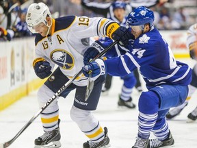 Maple Leafs' Morgan Rielly, right, and Buffalo Sabres' Cody Hodgson during NHL action at the Air Canada Centre in Toronto on Sept. 28, 2014.