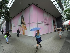In this June 27, 2013 archive photo, people walk past the location where the Victoria's Secrets store was due to open that summer. Opened in Aug. 2013, the store permanently closed this month.