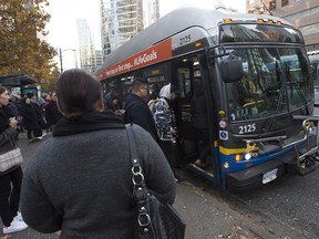 A union representing more than 180 transit workers in B.C. has issued a 72-hour strike notice. Passengers board a bus in downtown Vancouver, B.C., Friday, Nov. 1, 2019.