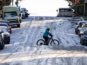 A cyclist bikes navigates an icy hill in Vancouver on Friday.