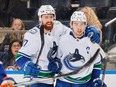 Filip Hronek and Quinn Hughes celebrate the Vancouver Canucks' captain scoring against the New York Islanders on Jan. 9. Hughes continues to lead all NHL defencemen in scoring with 64 points (12-52).