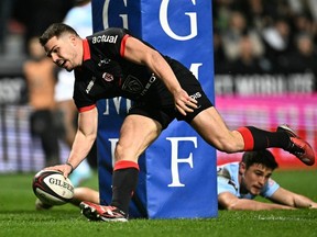Toulouse French fly-half Antoine Dupont scores a try during the French Top 14 rugby union match between Stade Toulousain (Toulouse) and Aviron Bayonnais (Bayonne) at the Ernest-Wallon Stadium in Toulouse, south-western France, on Feb. 3.