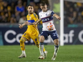 Whitecaps Ryan Gauld fights for the ball with Tigres' Fernando Gorriaran during the CONCACAF Champions League match at the Universitario stadium in Monterrey, Mexico, on Feb. 14.