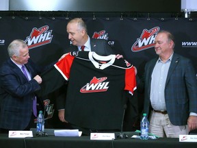 (L-R) Outgoing WHL commissioner Ron Robison, incoming Commissioner Dan Near and Ron Toigo, chairman of the WHL search committee meet on stage as Near is introduced as the new commissioner of the Western Hockey League in Calgary on Thursday, November 30, 2023. Jim Wells/Postmedia