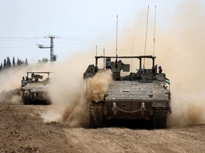 Israel tanks roll along the border with the Gaza Strip on Feb.23, 2024, amid ongoing battles between Israel and the Palestinian militant group Hamas.
