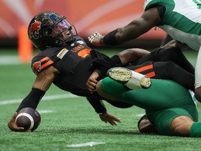 B.C. Lions quarterback Vernon Adams Jr., left, gets sacked by Saskatchewan Roughriders' Pete Robertson during their July 22 at BC Place. Adams left the game with a knee injury, and missed the next two games. Robertson is now a member of the Lions via CFL free agency.