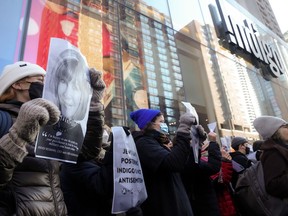Protesters gather outside an Indigo store in Toronto, on Thursday, Nov. 30, 2023. The demonstration, organized by the group gathered outside the bookstore chain owned by Heather Reisman, was partly in response to arrests made on November 10 after the store was vandalized with red paint. THE CANADIAN PRESS/Chris Young