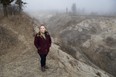 Sarah Emons, conservation director of Long Point Biosphere Region, stands near the edge of what locals call "the grand canyon,” a more than 300-metre crater called a gully sidewall caused by erosion on the shore of Lake Erie near Port Burwell. Photo taken on Friday, Feb. 23, 2024. (Derek Ruttan/The London Free Press)