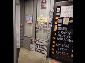 In an image taken from a video, B.C. MLA Selina Robinson's constituency office is seen vandalized with pro-Palestinian and anti-Israel messages, as well as calls for her to be kicked out of the NDP caucus.