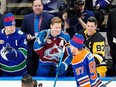 Elias Pettersson (left) congratulates Connor McDavid (centre) for winning the NHL All-Star skills competition on Friday. McDavid would later snub the Canucks in the podcast room.