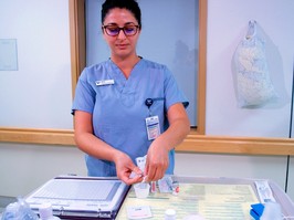 A nurse dispenses medication at a hospital.