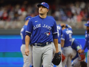 Toronto Blue Jays pitcher Erik Swanson walks to the dugout during a pitching change in the seventh inning of Game 2 of an AL wild-card baseball playoff series against the Minnesota Twins Wednesday, Oct. 4, 2023, in Minneapolis. Swanson will be away from the team indefinitely after his son was hit by a car and hospitalized on Sunday in Florida, manager John Schneider said.