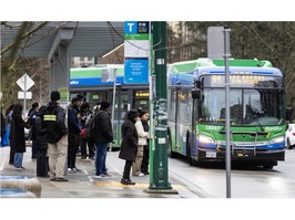 People wait to board buses at Joyce-Collingwood station in Vancouver, B.C., on February 20, 2024.