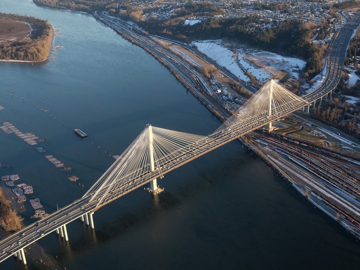 A file photo from 2018 shows an aerial view of Fraser River and the Port Mann Bridge during a vibrant winter sunset. Cable-stayed bridges with no piers minimize the impacts on the environment and marine users. But ice and snow can cause problems.