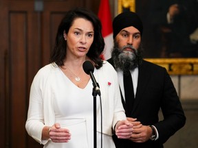 NDP MP Heather McPherson, front centre, and NDP Leader Jagmeet Singh hold a press conference in the foyer of the House of Commons in Ottawa on March 18.
