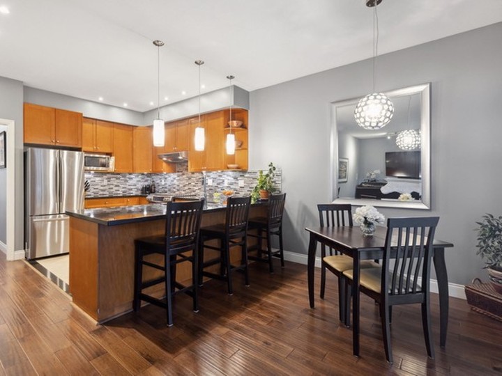  This Richmond home has an open kitchen with granite countertops and peninsular bar seating that overlooks an informal eating area and a family room.
