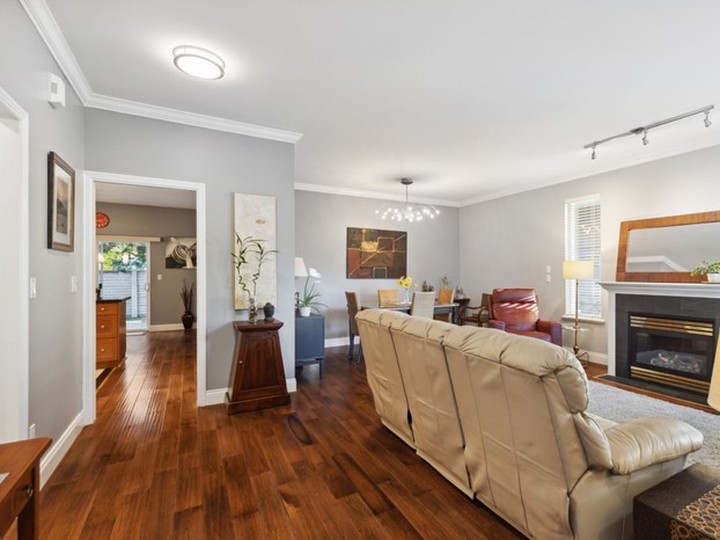  Nine-foot-high ceilings and gleaming laminate floors in a rich mocha tone on the main floor.