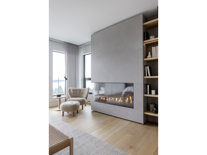  Contemporary furnishings and a modern fireplace create a sense of calm in the living room.